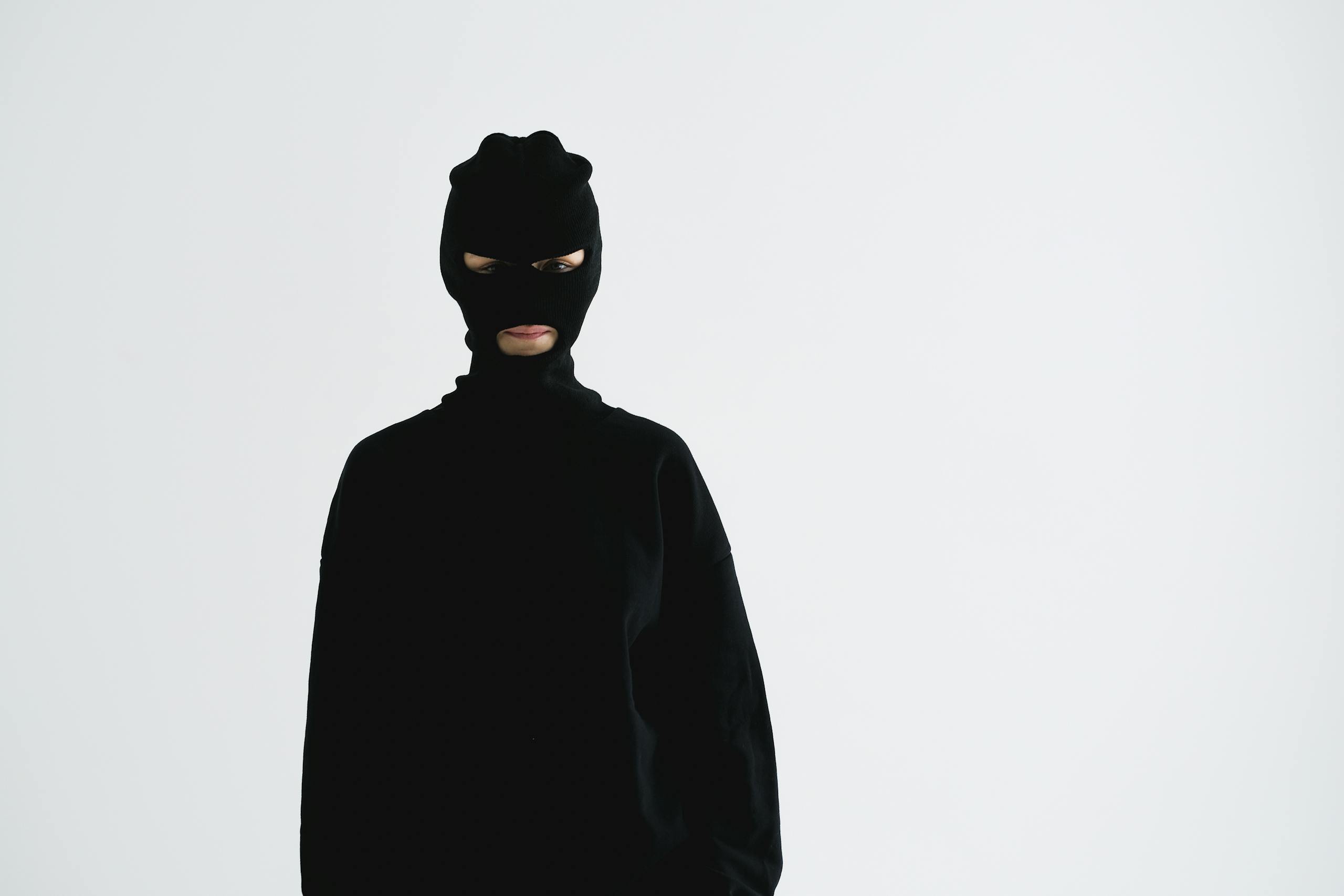 Portrait of an unrecognizable person in a balaclava, exuding a sense of mystery and anonymity.